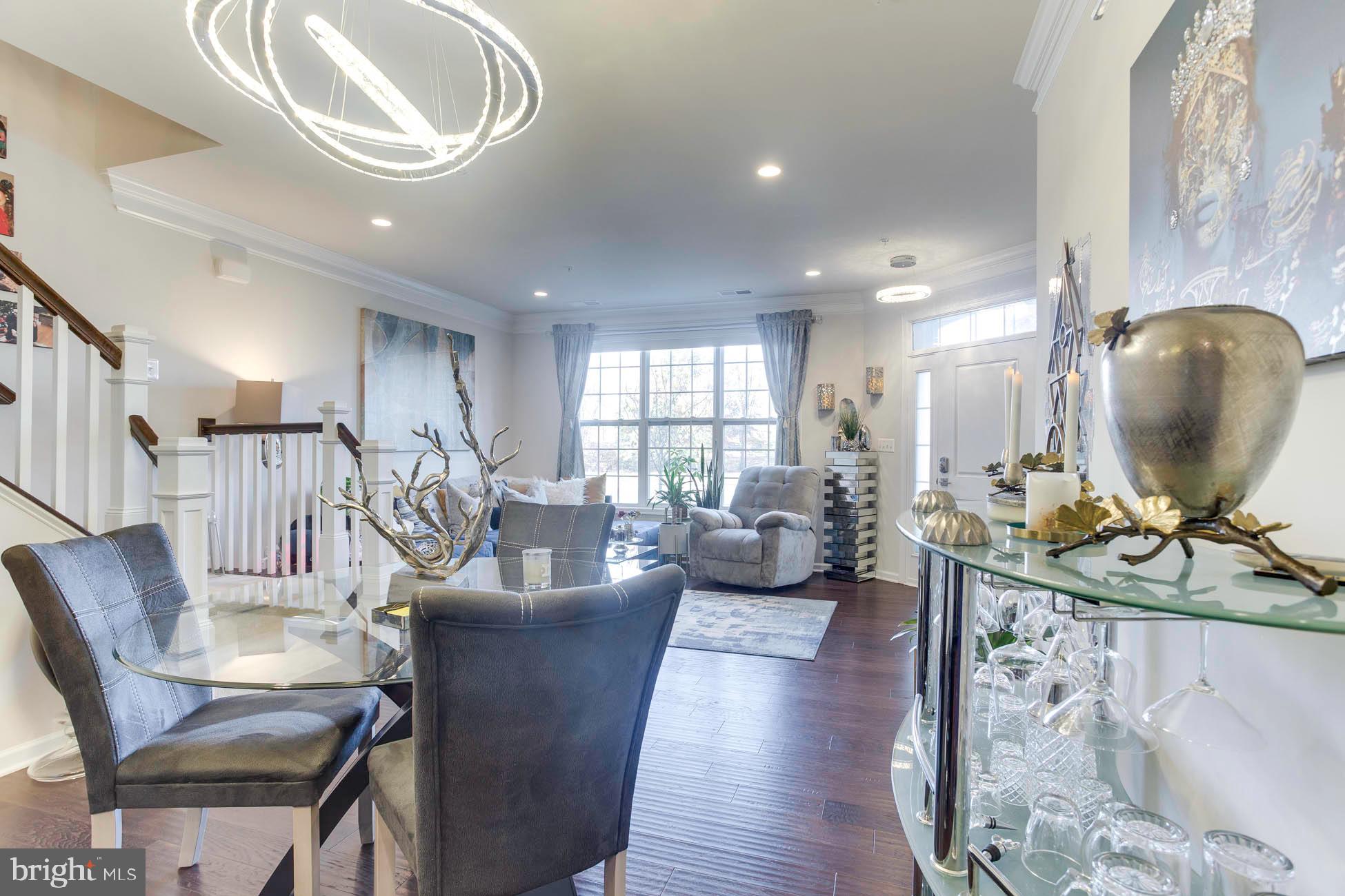 43048 Vernon Ridge Terrace Ashburn, VA 20148 - Photo 14 of 40 a living room with furniture a large window and wooden floor