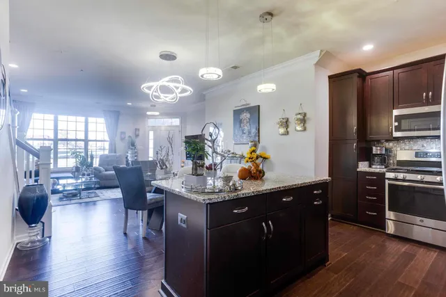 a kitchen with granite countertop a stove and cabinets