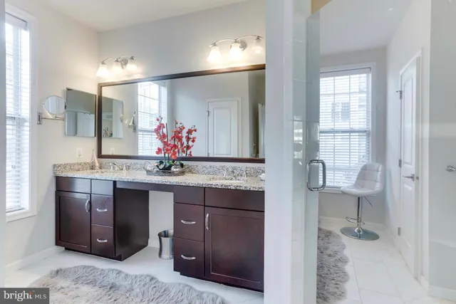 a bathroom with a sink double vanity and a mirror