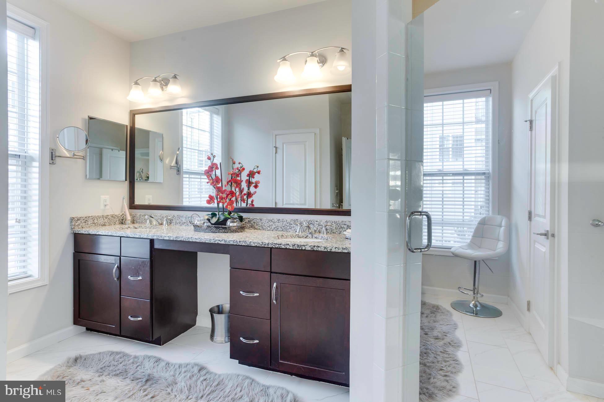 43048 Vernon Ridge Terrace Ashburn, VA 20148 - Photo 29 of 40 a bathroom with a sink double vanity and a mirror