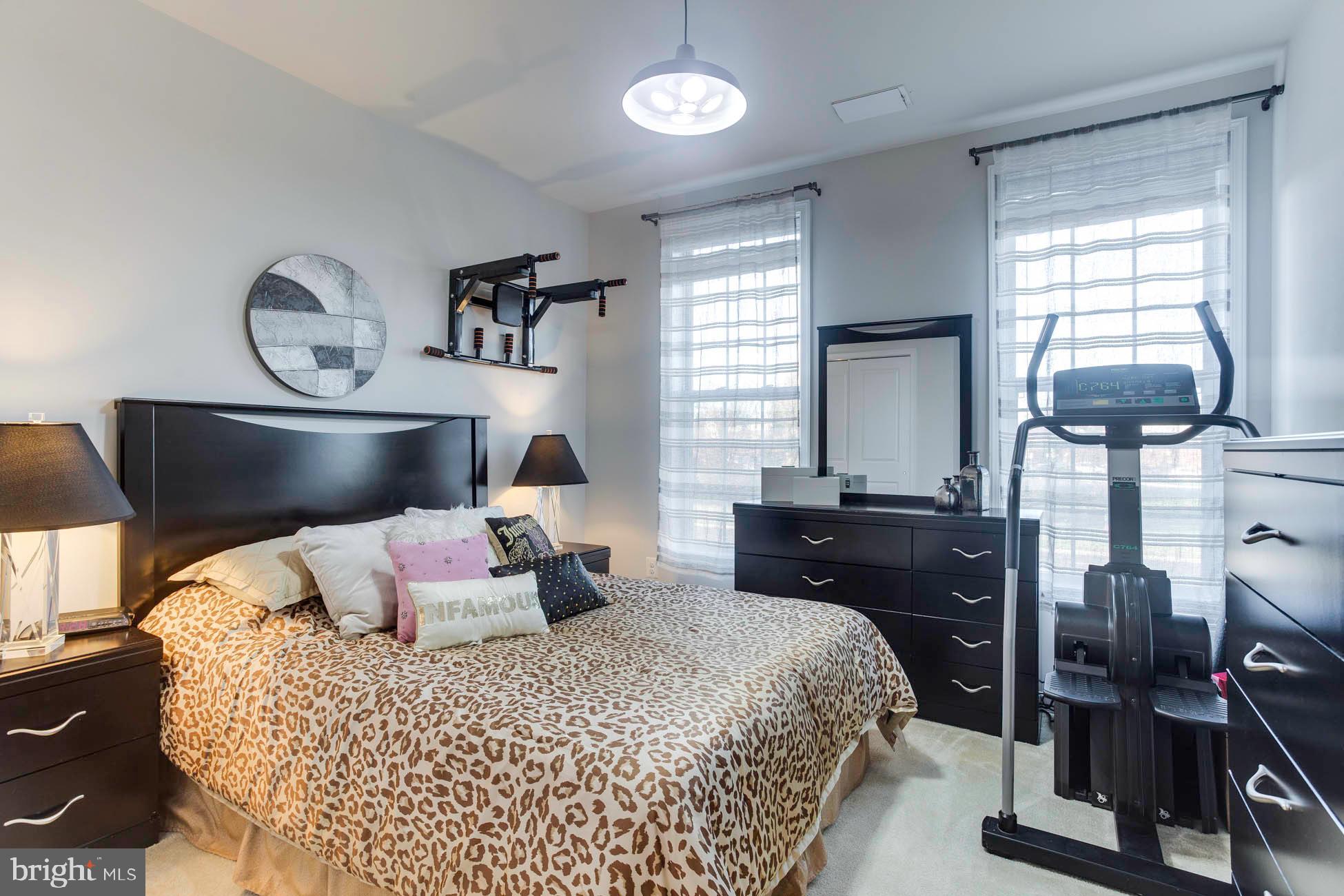 43048 Vernon Ridge Terrace Ashburn, VA 20148 - Photo 35 of 40 a bedroom with a bed and wooden floor