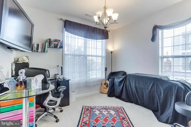 a bedroom with furniture and a window