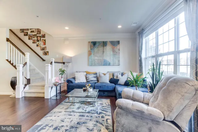 a living room with furniture and floor to ceiling windows