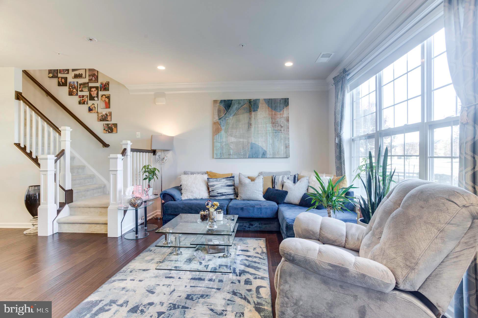 43048 Vernon Ridge Terrace Ashburn, VA 20148 - Photo 6 of 40 a living room with furniture and floor to ceiling windows