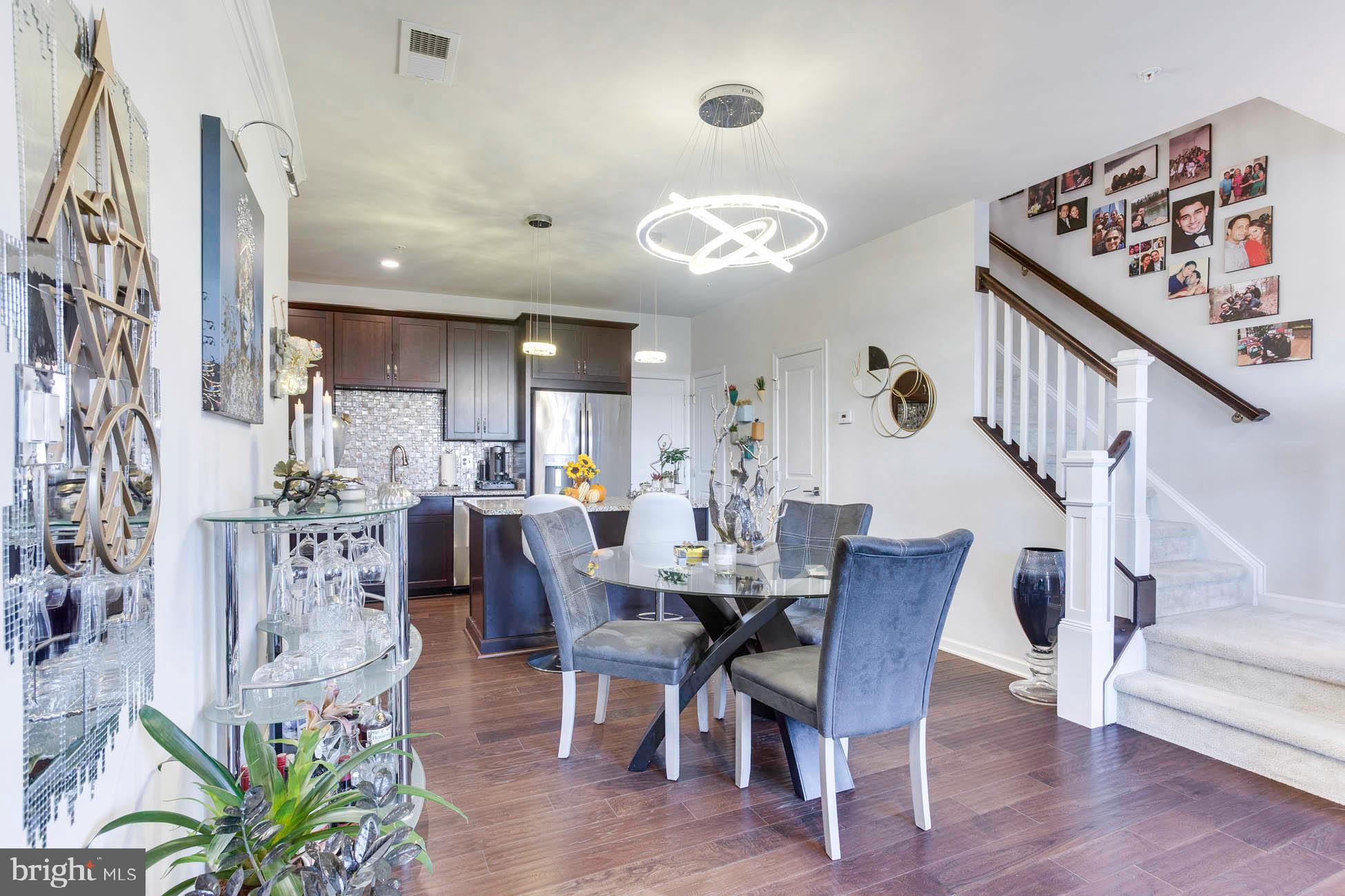 43048 Vernon Ridge Terrace Ashburn, VA 20148 - Photo 10 of 40 a view of a dining room with furniture and wooden floor
