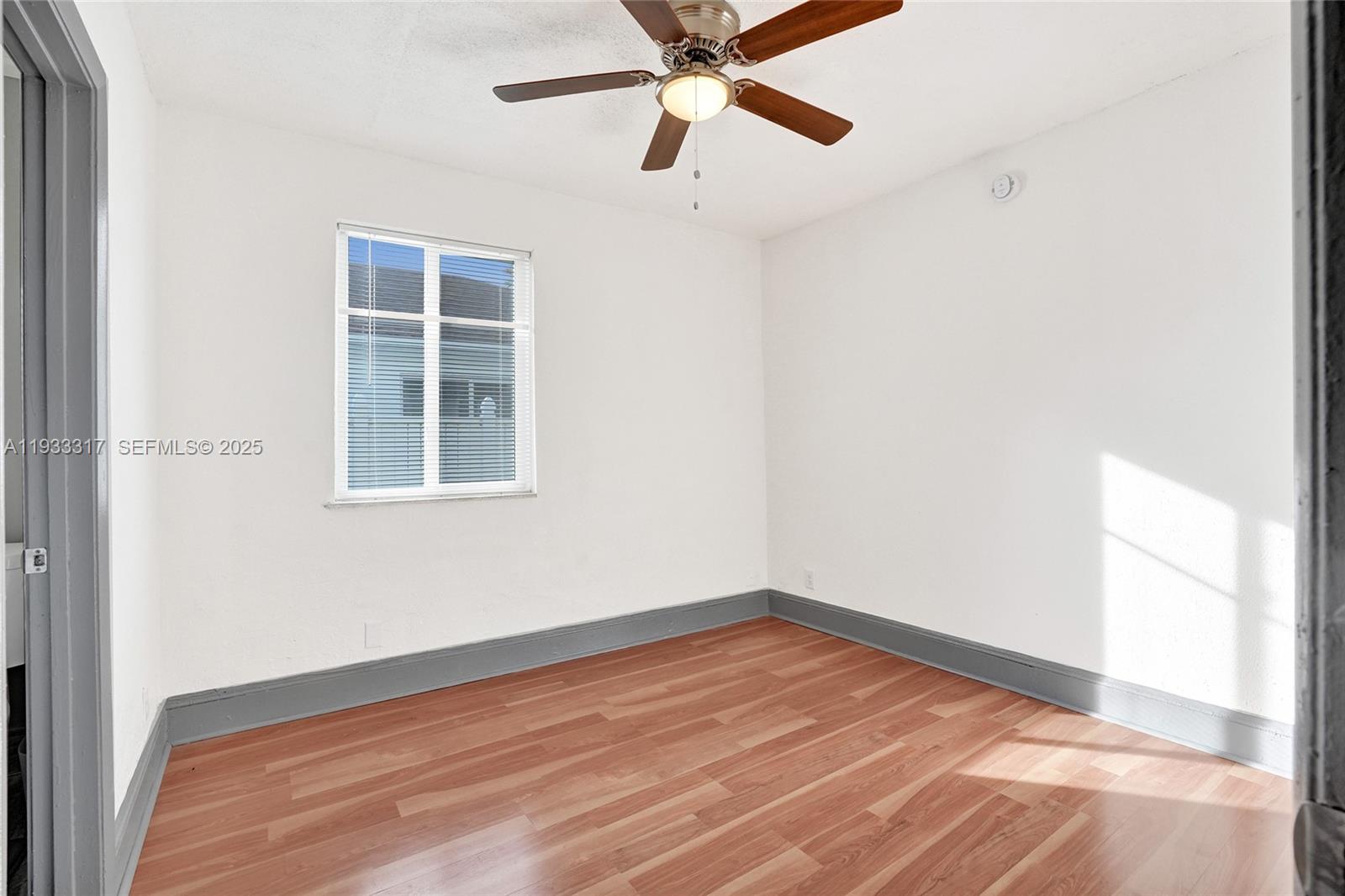 249 Southwest 4th Street, Unit 1 Dania Beach, FL 33004 - Photo 12 of 40 a view of empty room with wooden floor and fan