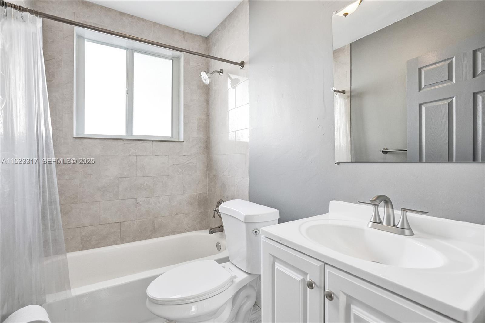 249 Southwest 4th Street, Unit 1 Dania Beach, FL 33004 - Photo 14 of 40 a bathroom with a sink toilet and shower