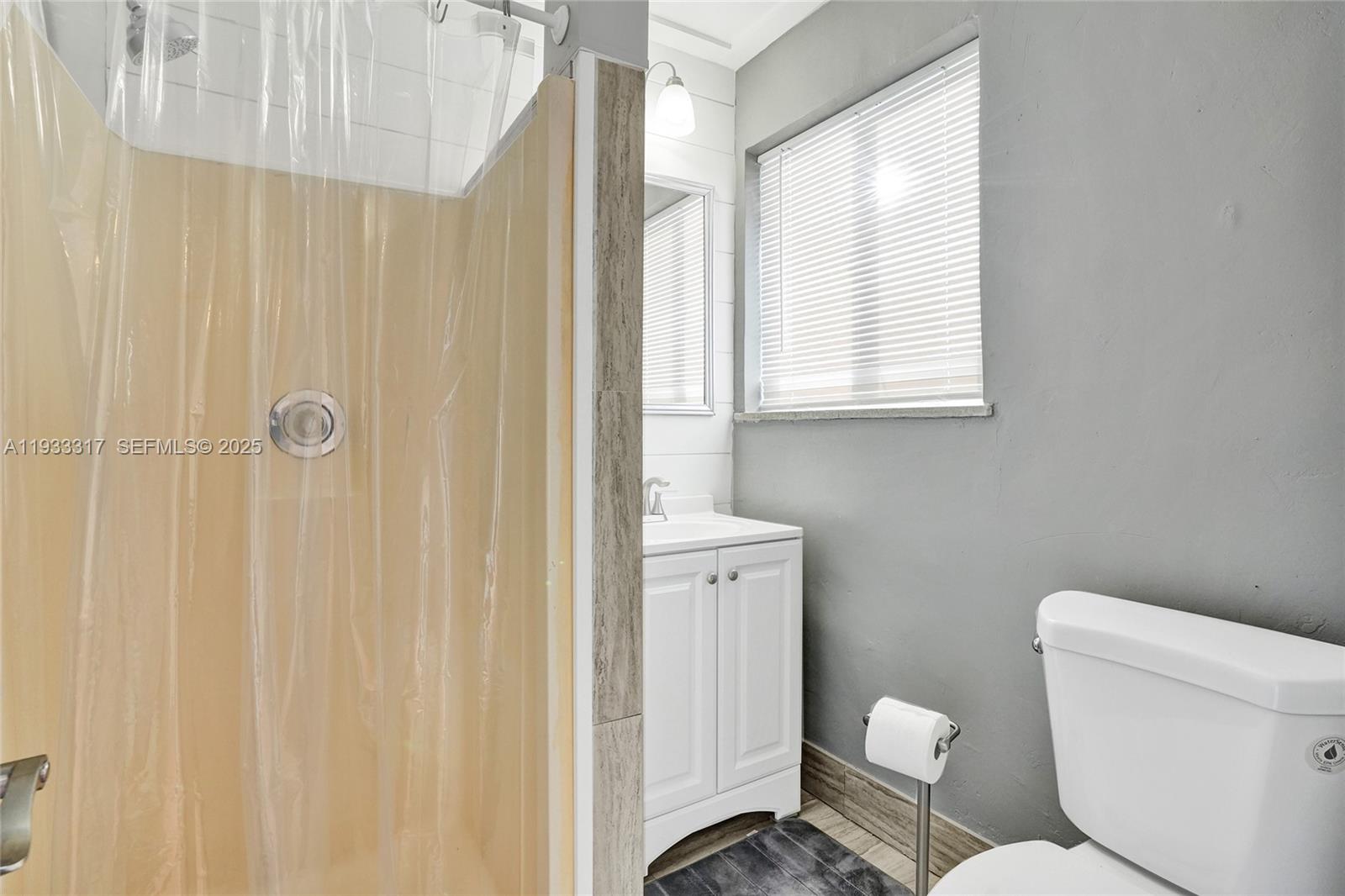 249 Southwest 4th Street, Unit 1 Dania Beach, FL 33004 - Photo 15 of 40 a white toilet sitting next to a bathroom sink