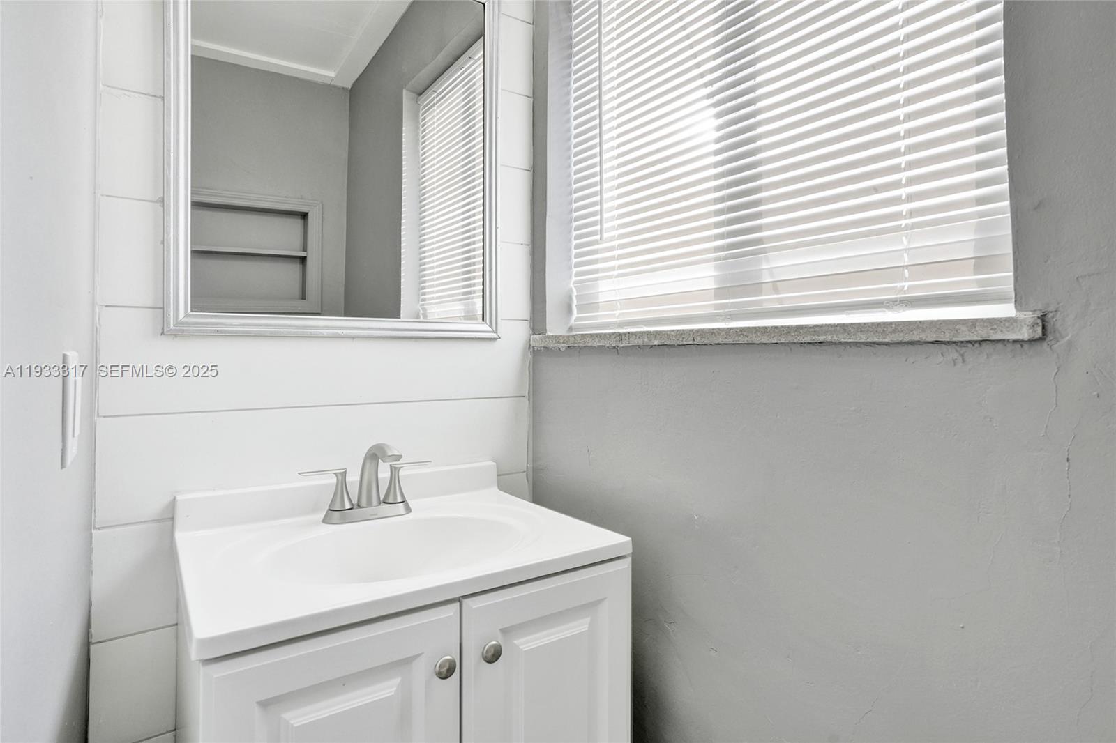 249 Southwest 4th Street, Unit 1 Dania Beach, FL 33004 - Photo 16 of 40 a bathroom with a sink and a window