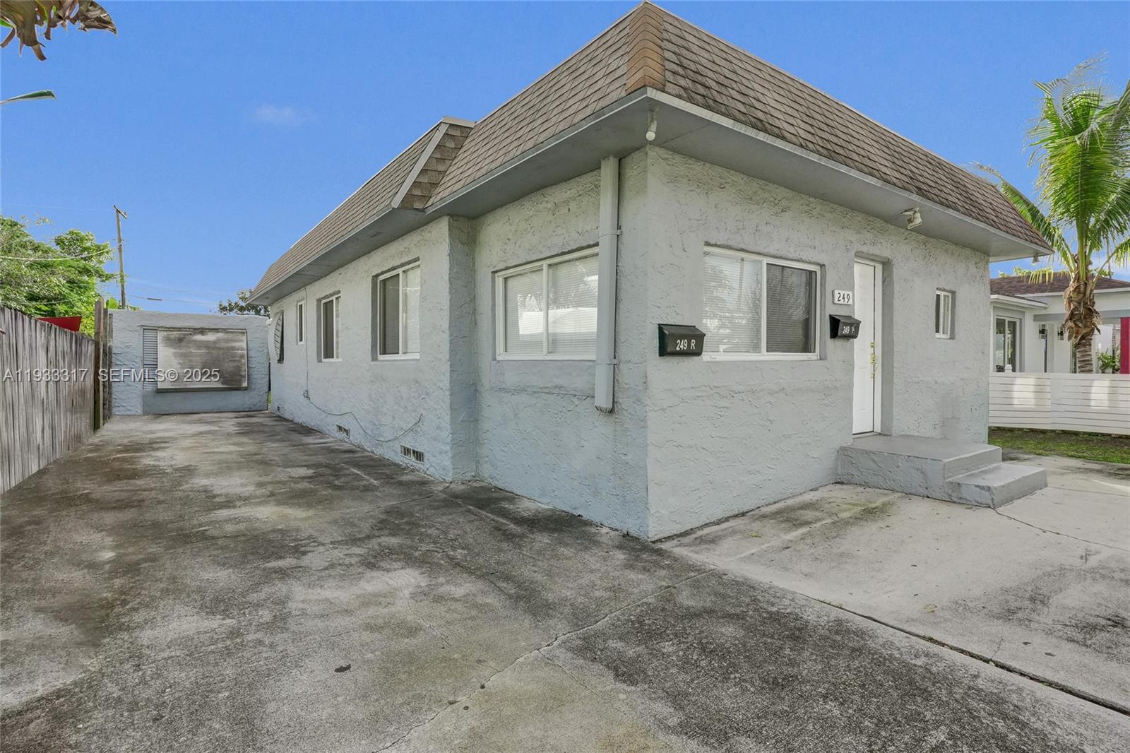 249 Southwest 4th Street, Unit 1 Dania Beach, FL 33004 - Photo 2 of 40 a front view of a house with a yard