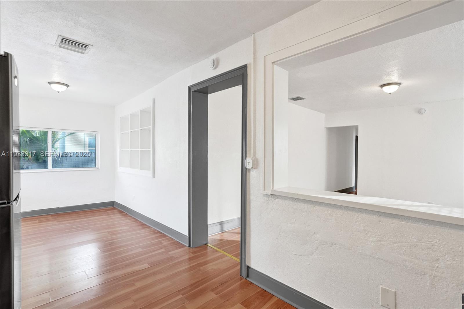 249 Southwest 4th Street, Unit 1 Dania Beach, FL 33004 - Photo 24 of 40 wooden floor in an empty room with a window