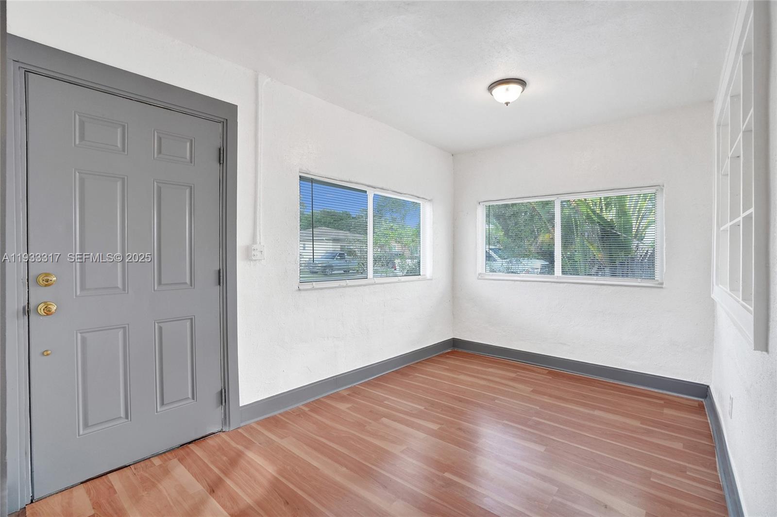 249 Southwest 4th Street, Unit 1 Dania Beach, FL 33004 - Photo 25 of 40 a view of empty room with wooden floor and fan