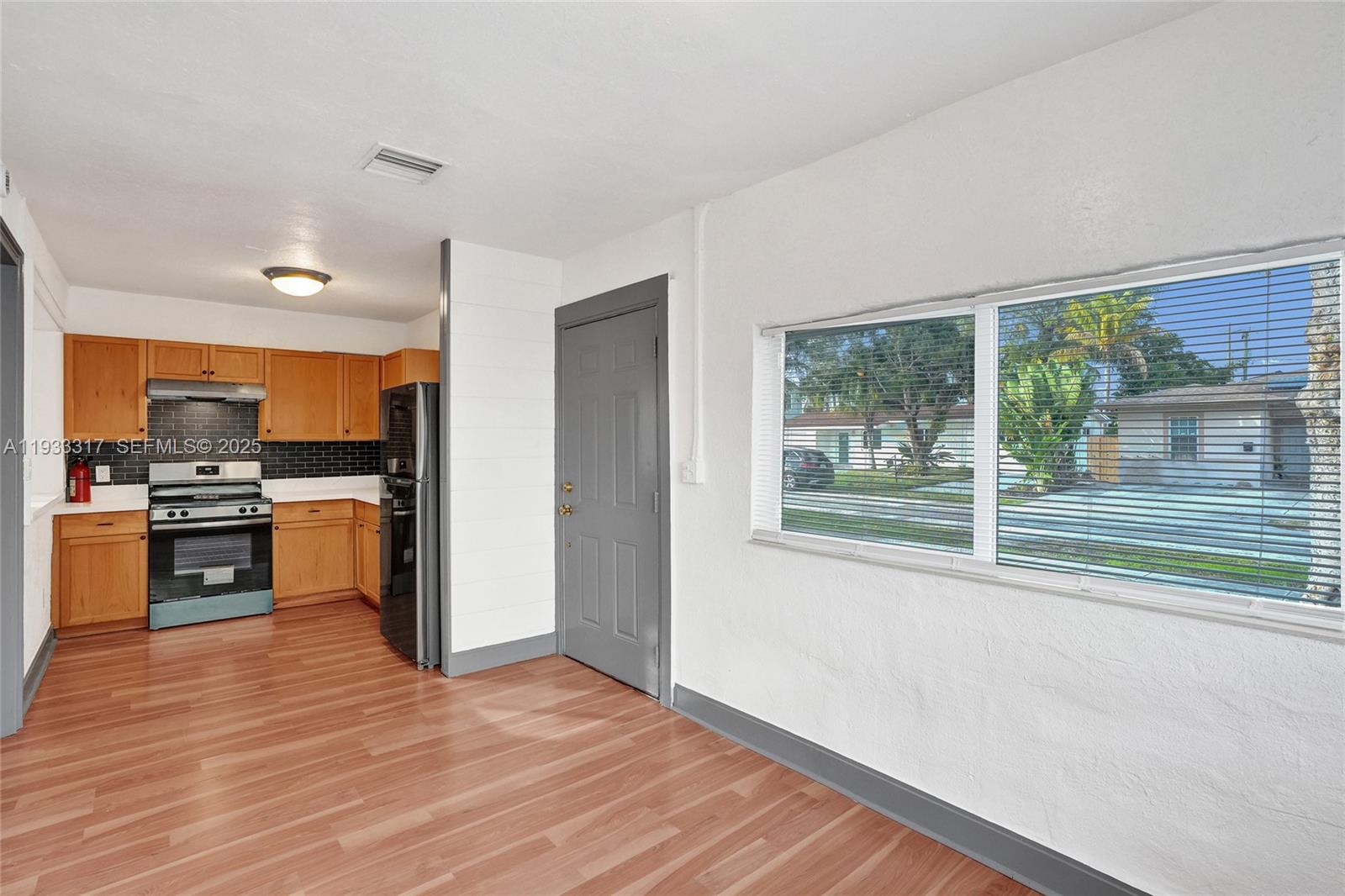249 Southwest 4th Street, Unit 1 Dania Beach, FL 33004 - Photo 26 of 40 a kitchen with a refrigerator and a stove top oven