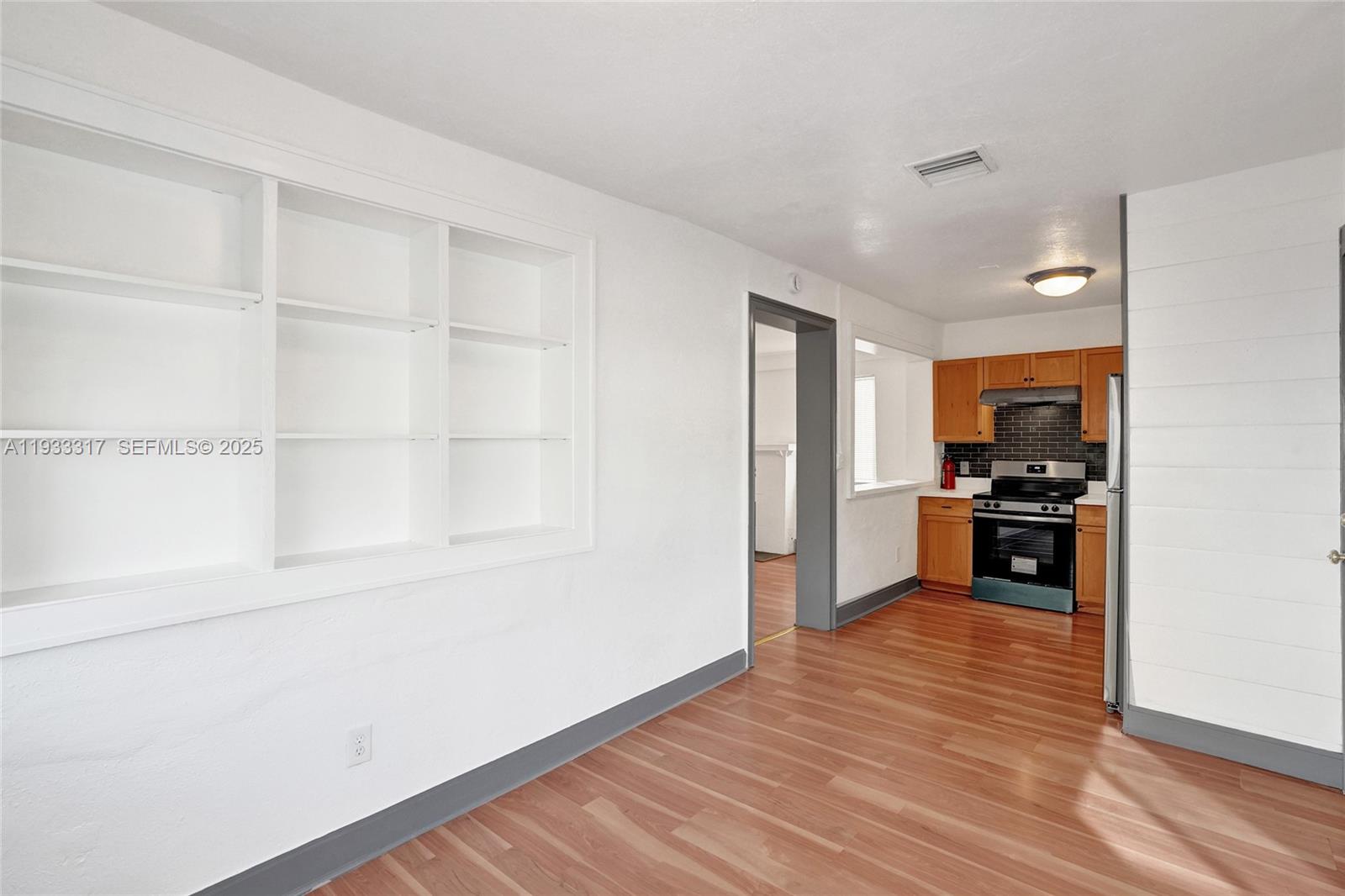 249 Southwest 4th Street, Unit 1 Dania Beach, FL 33004 - Photo 27 of 40 a kitchen with granite countertop a stove and a refrigerator