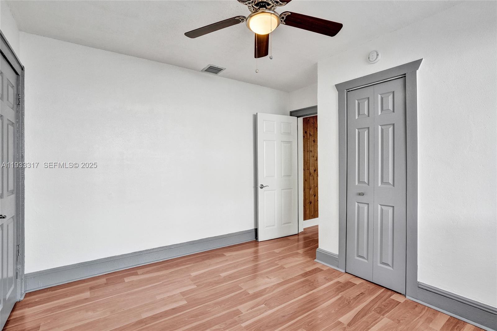 249 Southwest 4th Street, Unit 1 Dania Beach, FL 33004 - Photo 7 of 40 a view of an empty room with wooden floor