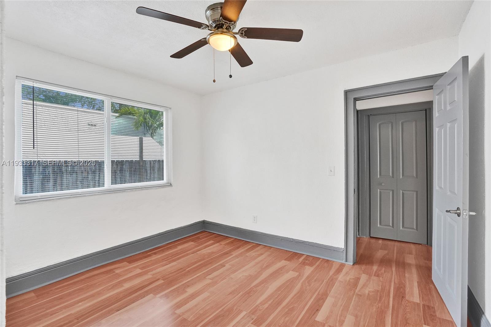 249 Southwest 4th Street, Unit 1 Dania Beach, FL 33004 - Photo 8 of 40 a view of empty room with wooden floor and fan