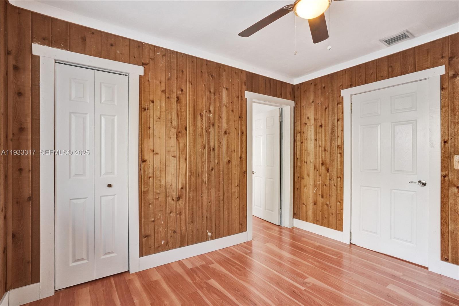 249 Southwest 4th Street, Unit 1 Dania Beach, FL 33004 - Photo 10 of 40 an empty room with wooden floor and entryway