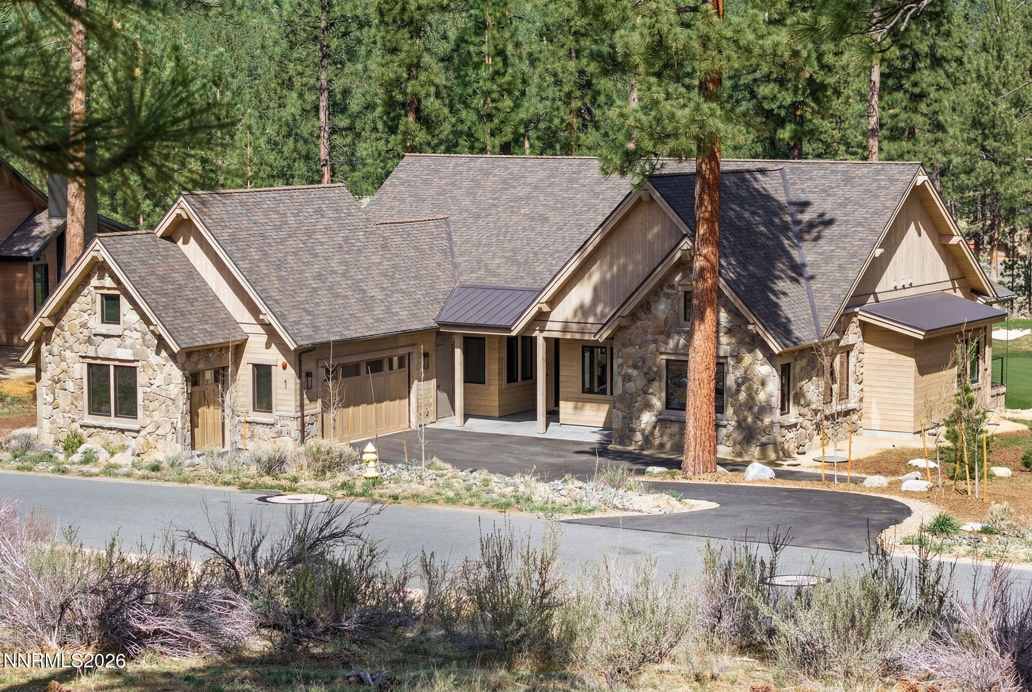 a front view of a house with a yard covered with snow in front of house