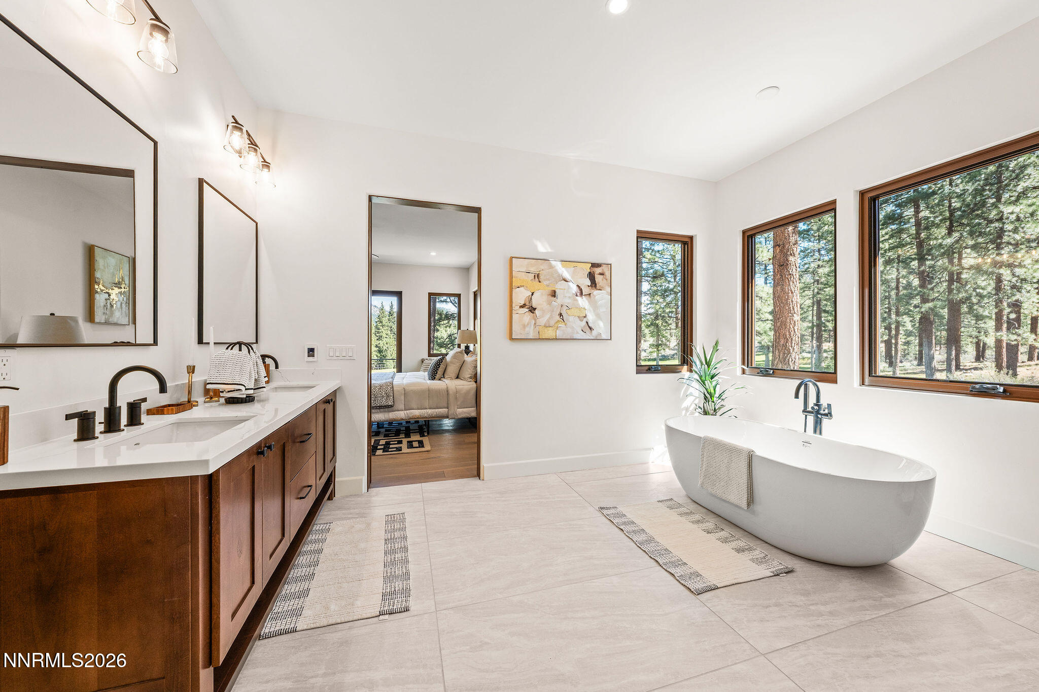 456 Headwaters Way Carson City, NV 89705 - Photo 14 of 40 a spacious bathroom with a double vanity sink large mirror and a bathtub