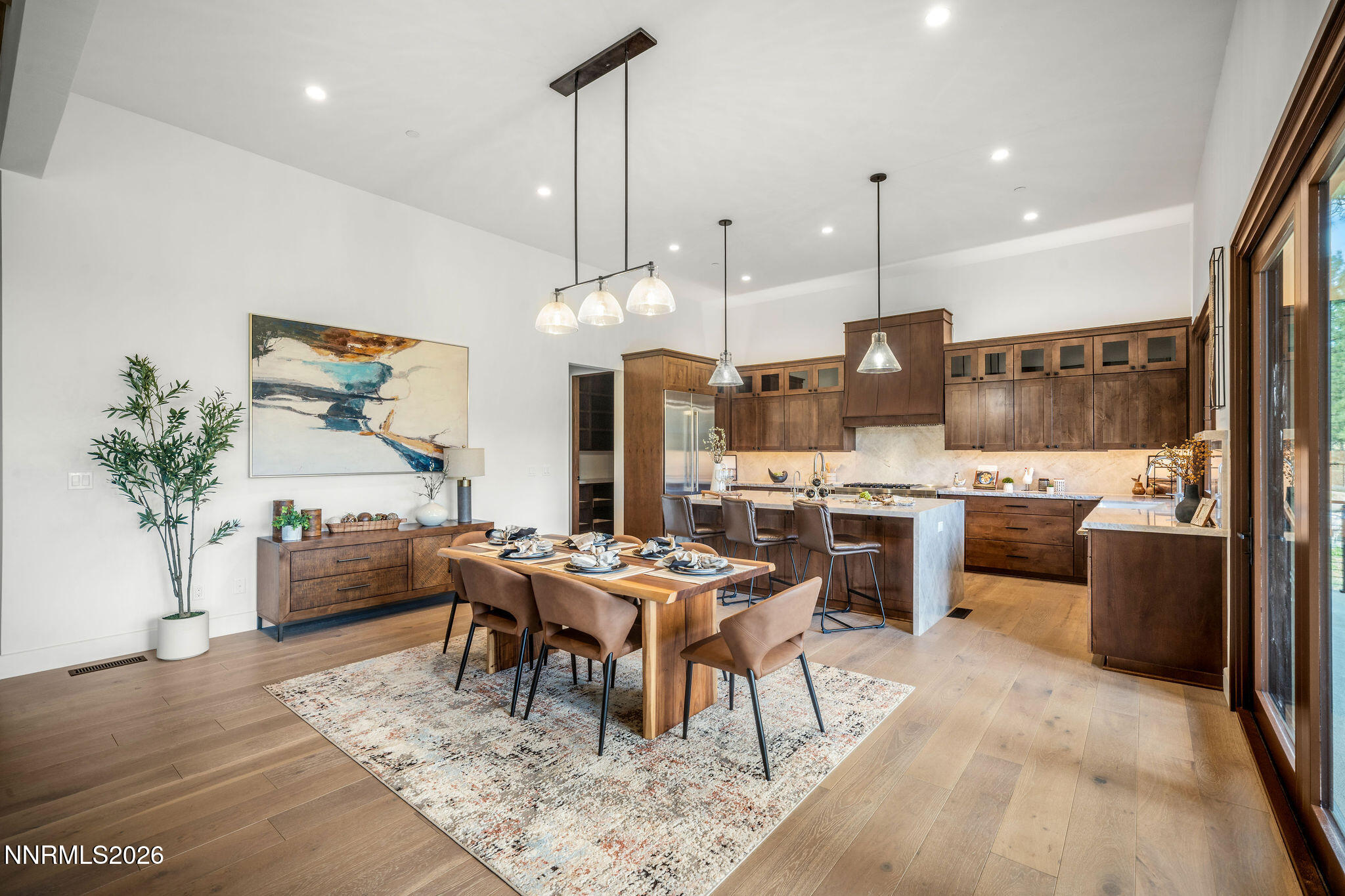 456 Headwaters Way Carson City, NV 89705 - Photo 8 of 40 a kitchen with stainless steel appliances kitchen island granite countertop a table chairs and a refrigerator