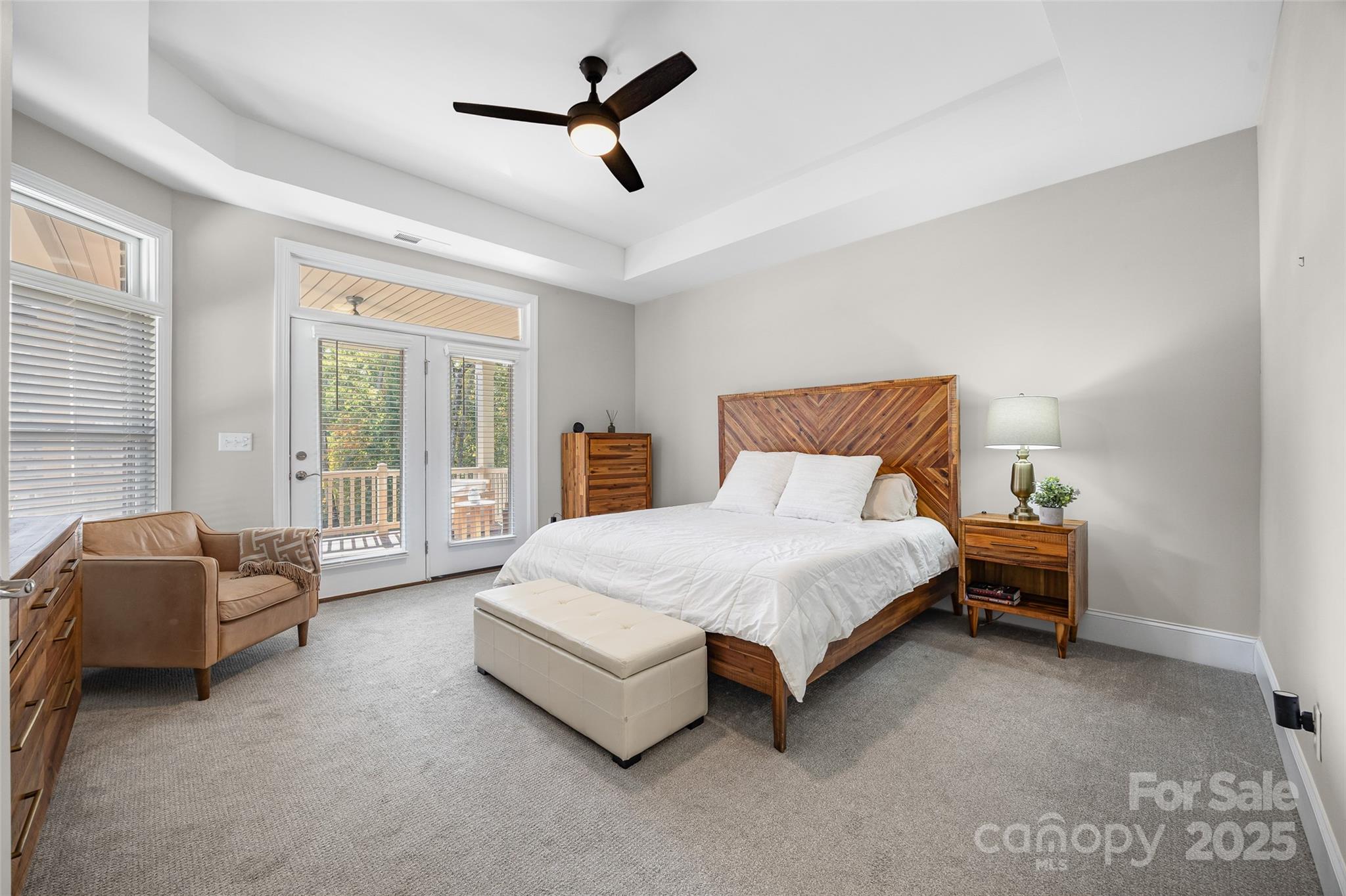 2031 New Style Way Tega Cay, SC 29708 - Photo 11 of 38 a spacious bedroom with a bed a couch and a large window