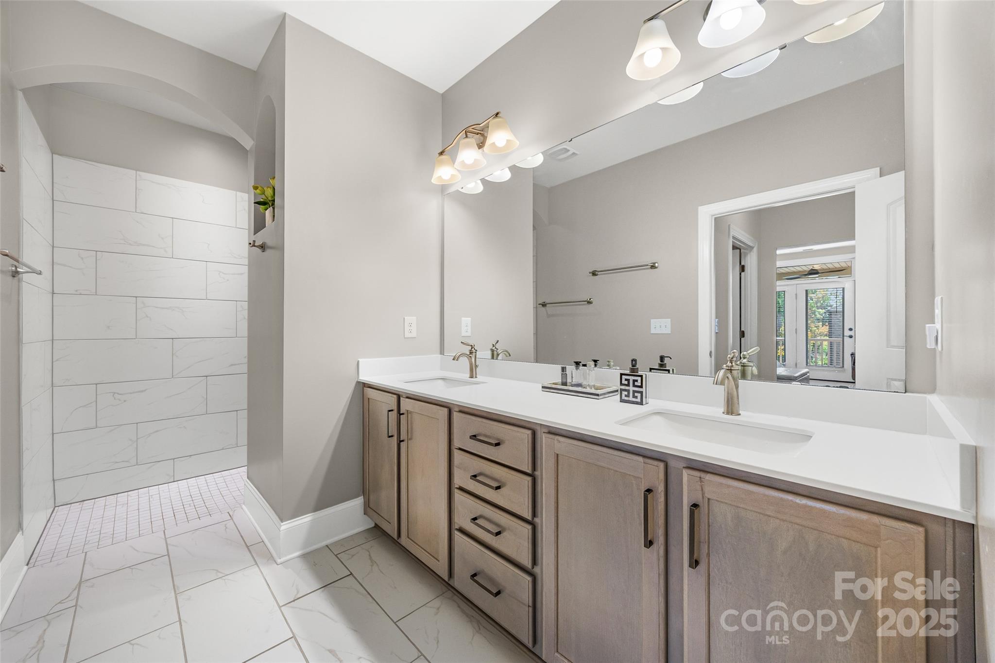 2031 New Style Way Tega Cay, SC 29708 - Photo 14 of 38 a bathroom with a double vanity sink and a mirror