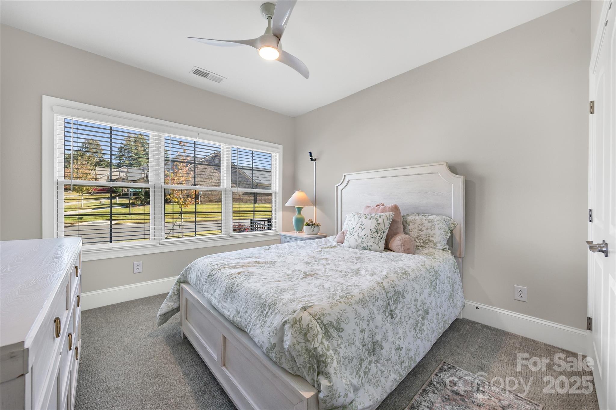 2031 New Style Way Tega Cay, SC 29708 - Photo 16 of 38 a bed sitting in a spacious bedroom next to a window