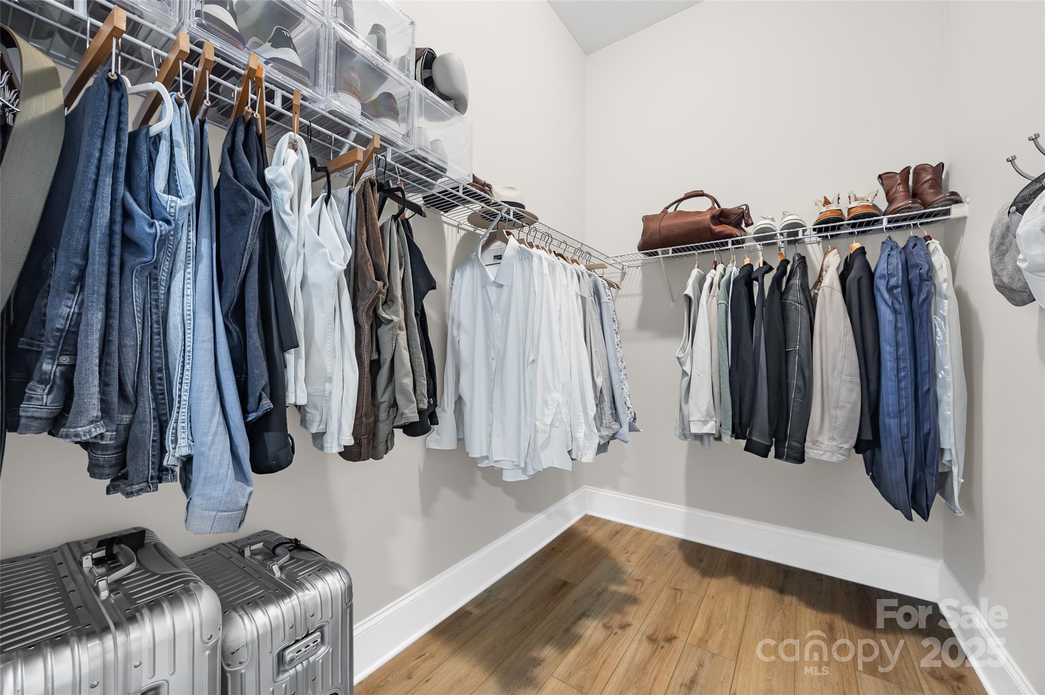 2031 New Style Way Tega Cay, SC 29708 - Photo 25 of 38 a view of walk in closet with clothes and shoes