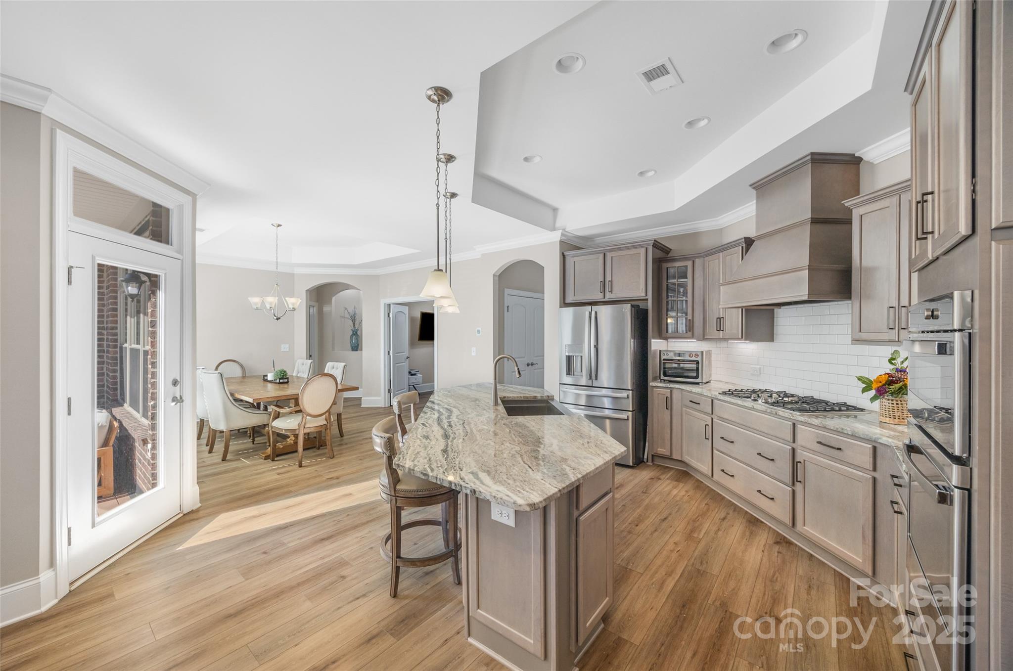 2031 New Style Way Tega Cay, SC 29708 - Photo 3 of 38 a large kitchen with stainless steel appliances lots of counter space and windows