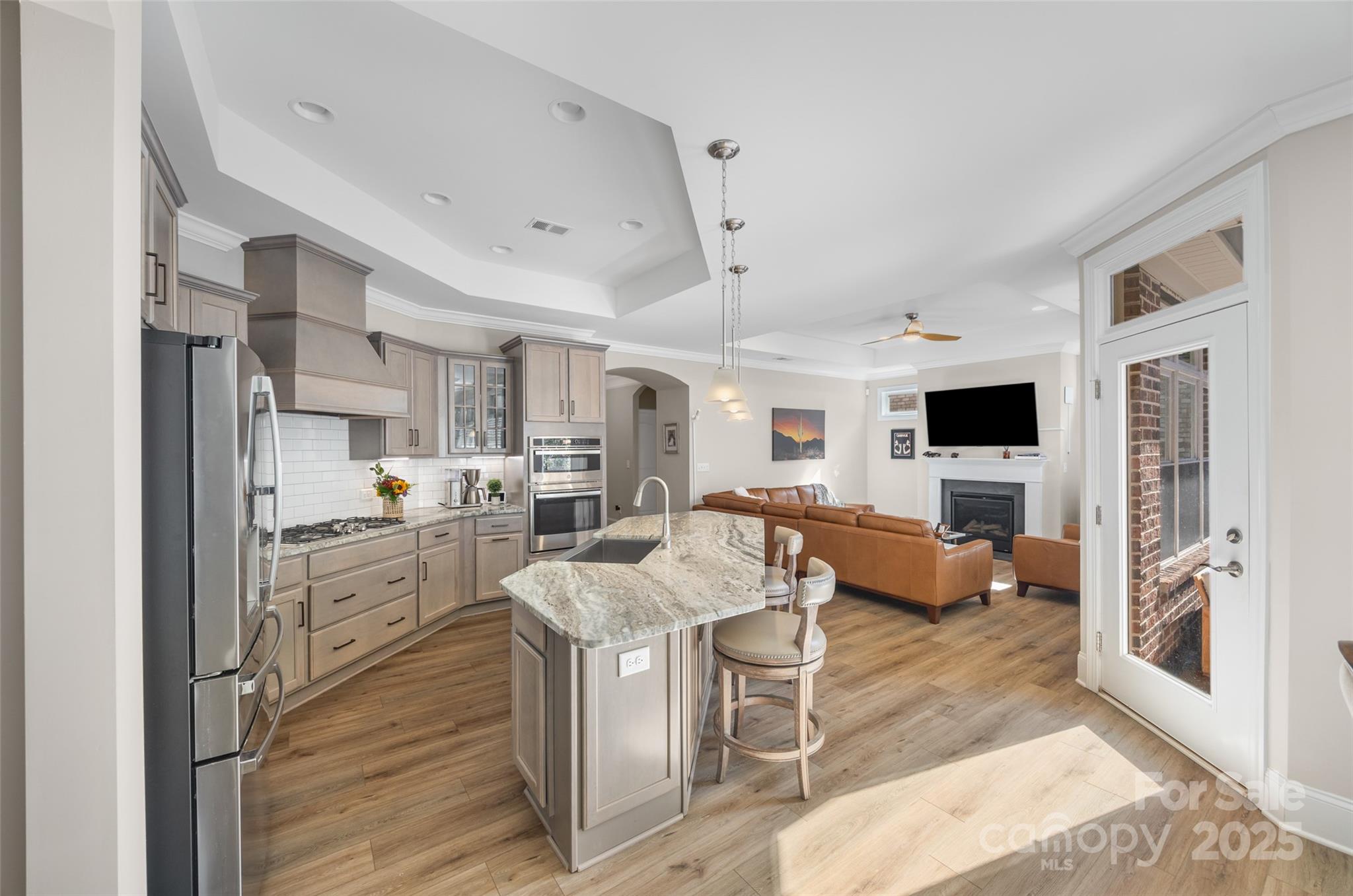 2031 New Style Way Tega Cay, SC 29708 - Photo 4 of 38 a living room with stainless steel appliances furniture and a kitchen view
