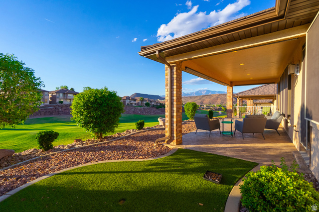 2212 Chippenham Court St. George, UT 84770 - Photo 30 of 75 View of grassy yard featuring outdoor furniture, a patio area, and a mountain view