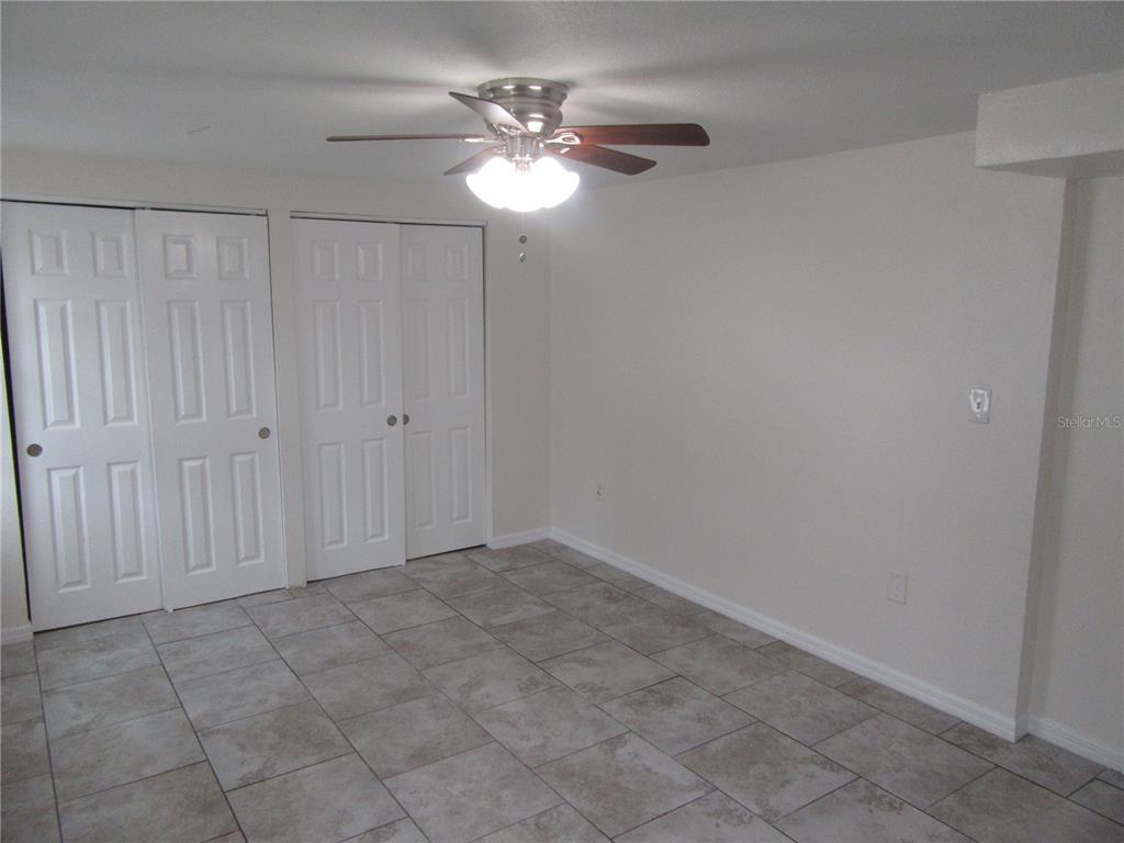 11913 104th Street Largo, FL 33773 - Photo 16 of 34 an empty room with chandelier fan
