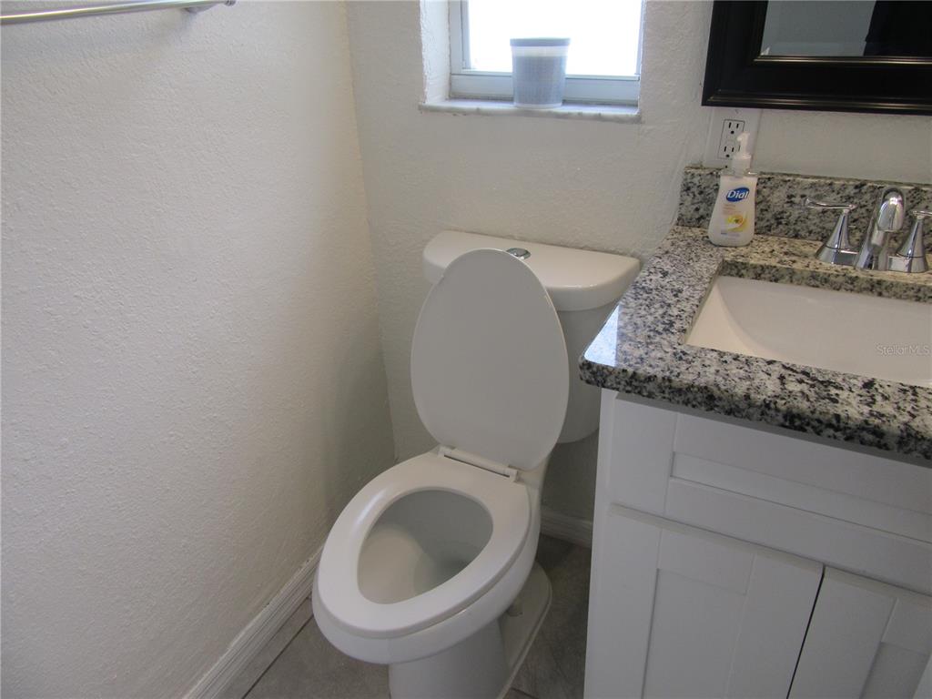 11913 104th Street Largo, FL 33773 - Photo 21 of 34 a close view of a sink and a toilet