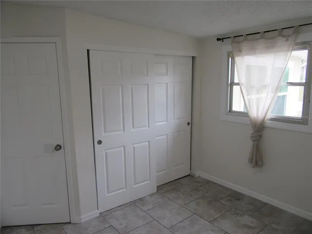 a view of an empty room with a window