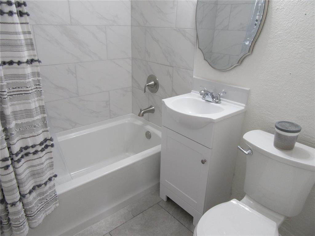 11913 104th Street Largo, FL 33773 - Photo 26 of 34 a bathroom with a sink toilet and bathtub