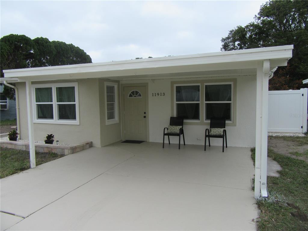 11913 104th Street Largo, FL 33773 - Photo 3 of 34 a backyard of a house with table and chairs