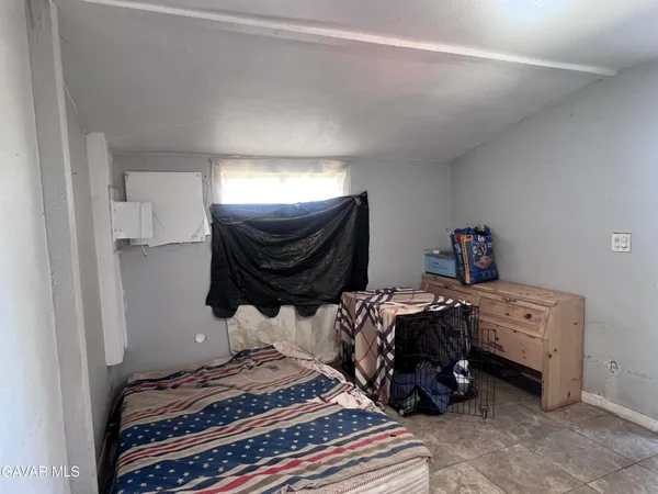 a bedroom with a bed and a television
