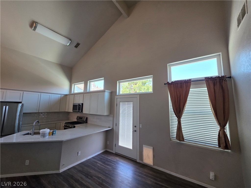 2275 Ramsgate Drive Henderson, NV 89074 - Photo 37 of 84 Culinary adventures await in this kitchen, boasting vaulted ceilings and abundant natural light.