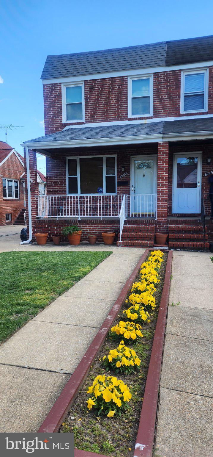 6713 1/2 German Hill Road Baltimore, MD 21222 - Photo 2 of 7 Charming brick home with vibrant blooms.