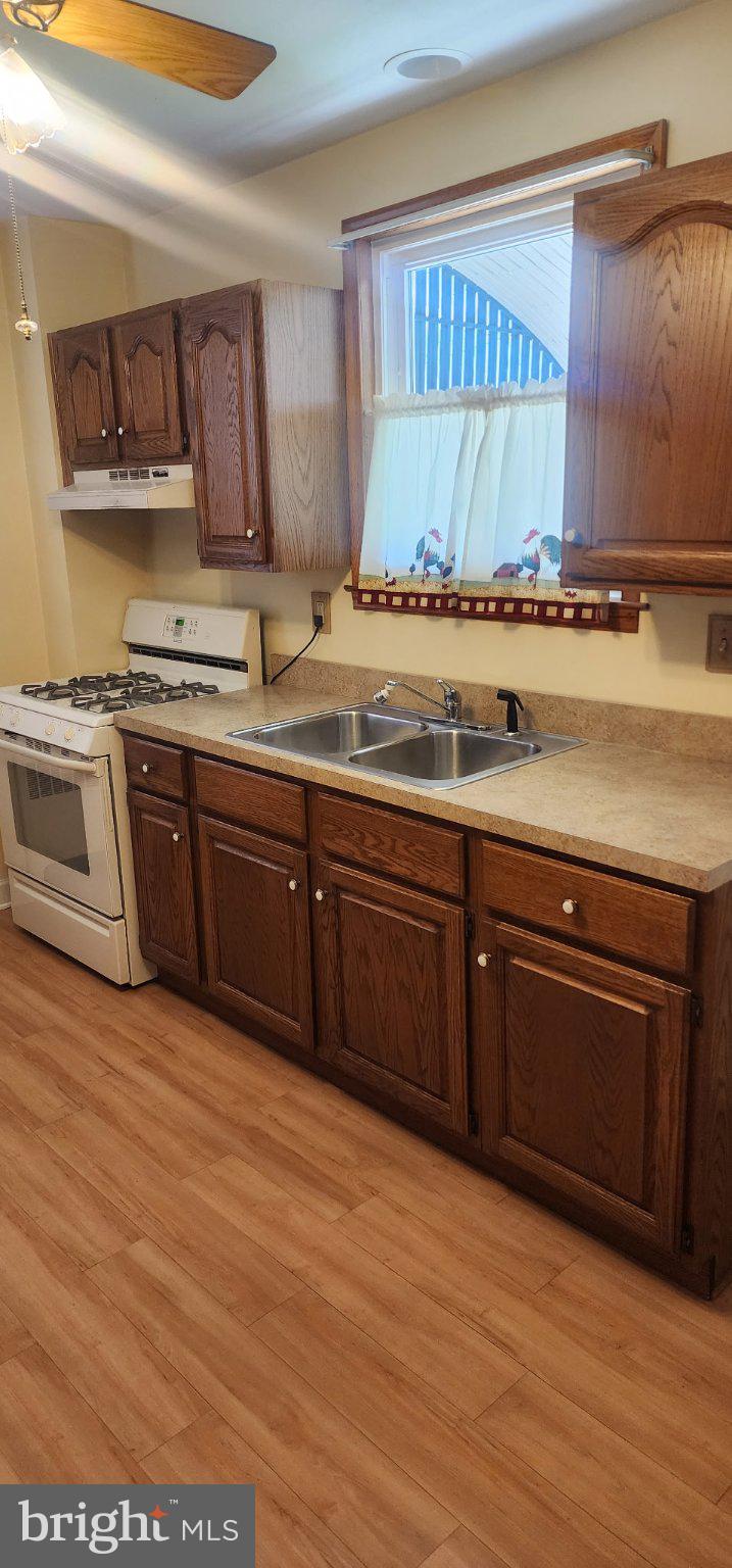 6713 1/2 German Hill Road Baltimore, MD 21222 - Photo 4 of 7 Cozy kitchen with warm wooden accents.