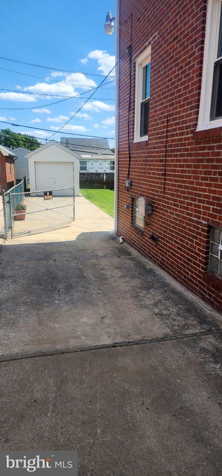 6713 1/2 German Hill Road Baltimore, MD 21222 - Photo 7 of 7 Charming alleyway with sunny skies.
