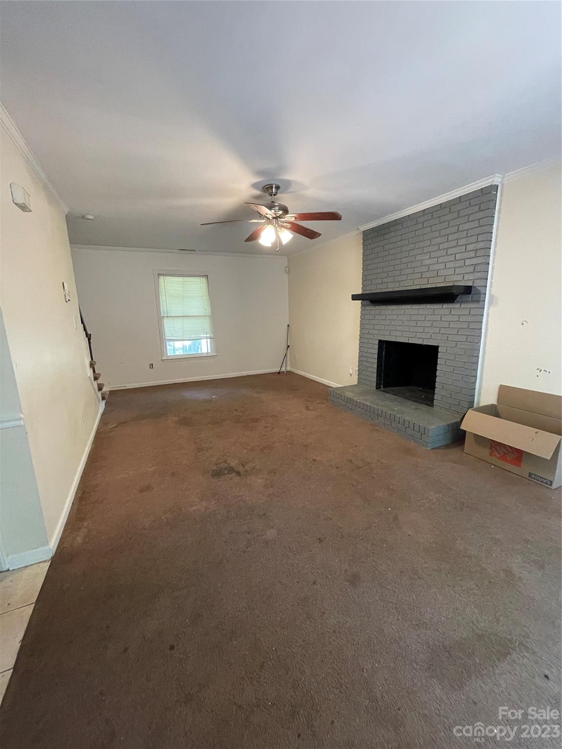 2819 Royal Ridge Lane Charlotte, NC 28212 - Photo 12 of 27 an empty room with windows and fireplace
