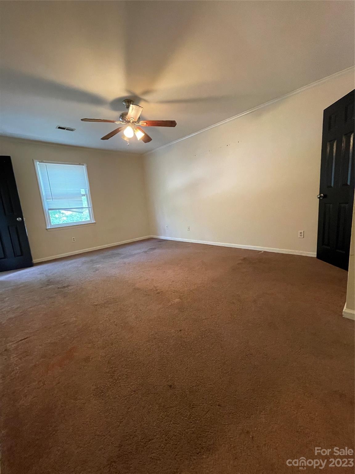 2819 Royal Ridge Lane Charlotte, NC 28212 - Photo 14 of 27 an empty room with windows and fan