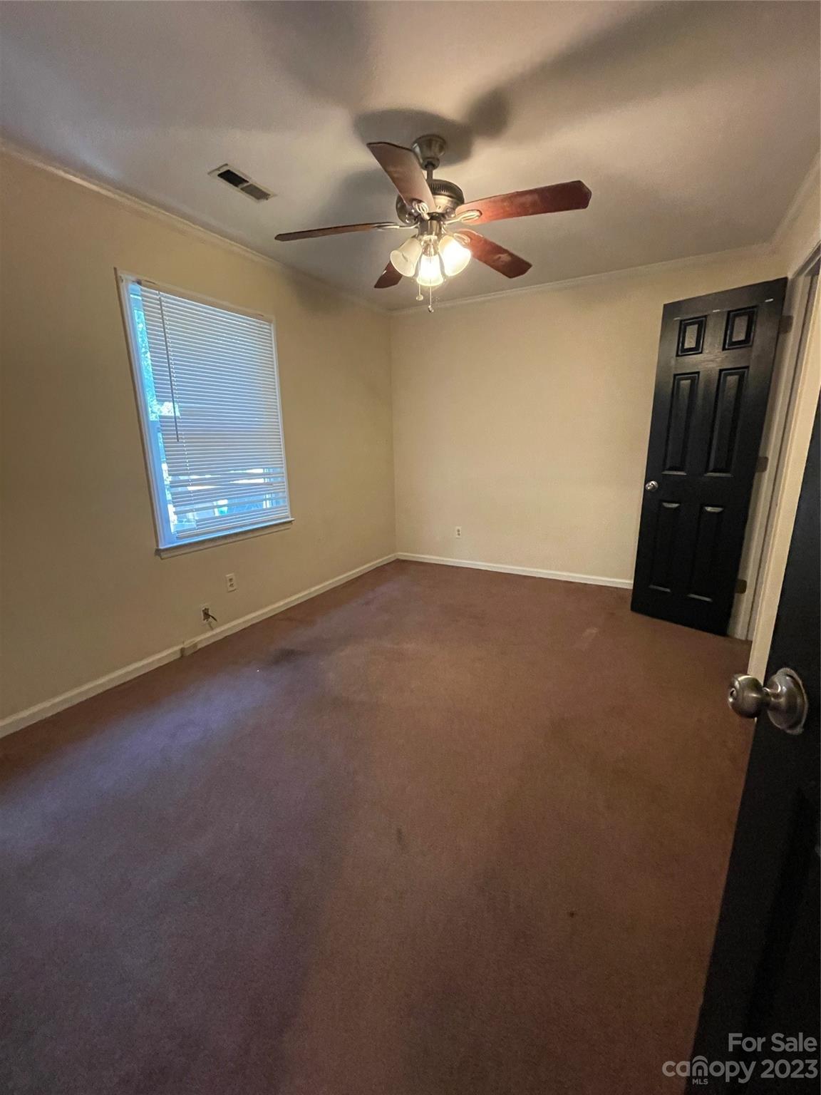 2819 Royal Ridge Lane Charlotte, NC 28212 - Photo 20 of 27 an empty room with windows and fan