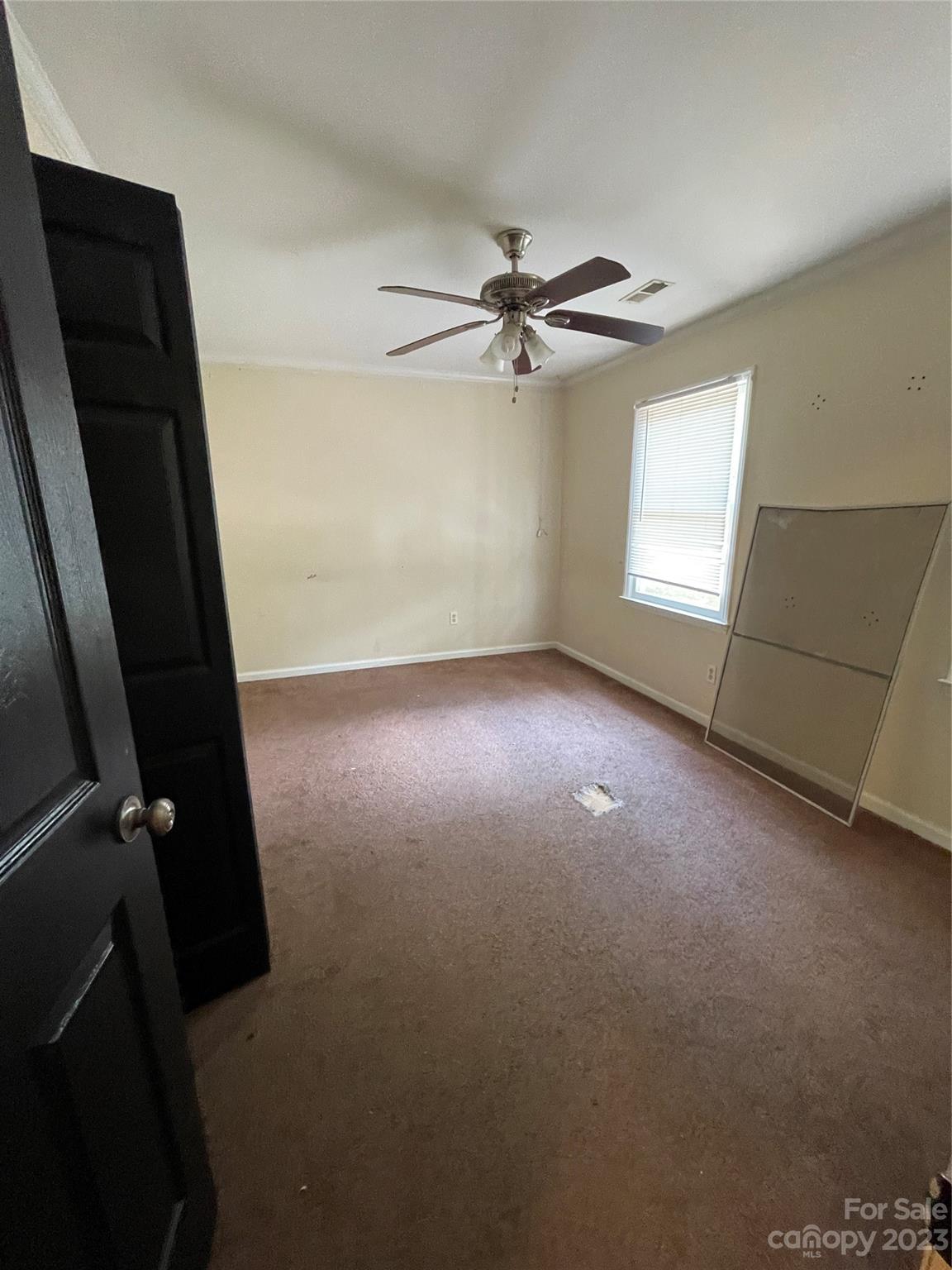 2819 Royal Ridge Lane Charlotte, NC 28212 - Photo 21 of 27 an empty room with windows and fan