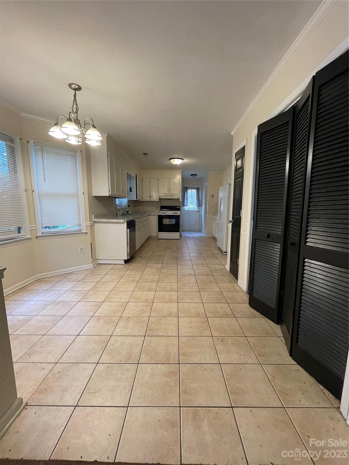 2819 Royal Ridge Lane Charlotte, NC 28212 - Photo 8 of 27 a view of a refrigerator in kitchen and an empty room with windows