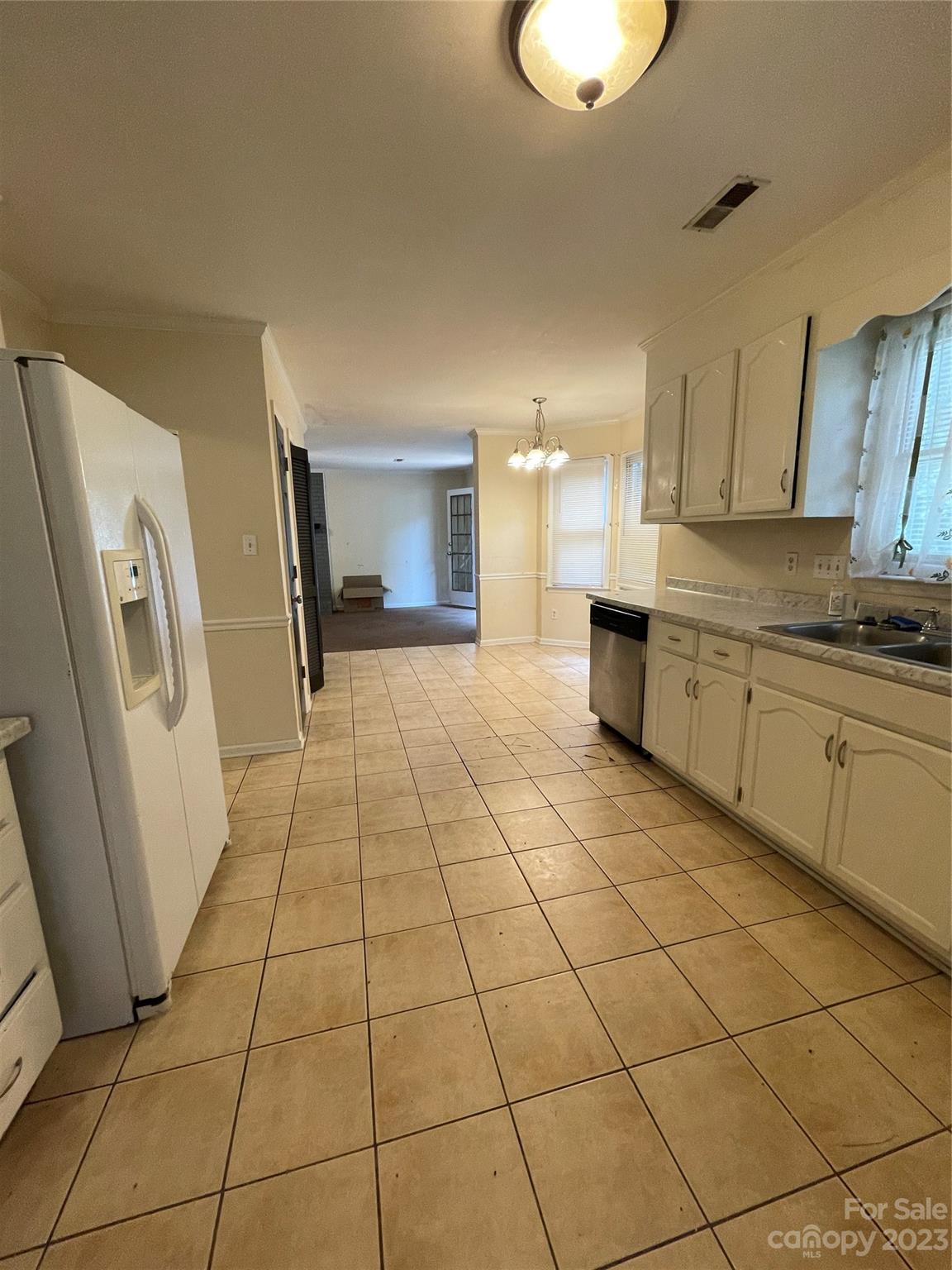 2819 Royal Ridge Lane Charlotte, NC 28212 - Photo 10 of 27 a large white kitchen with a sink and cabinets