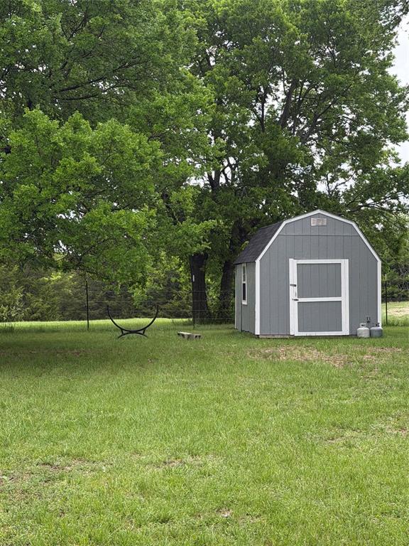 627 Homer Smith Road Van Alstyne, TX 75495 - Photo 27 of 36 a view of a house with a yard
