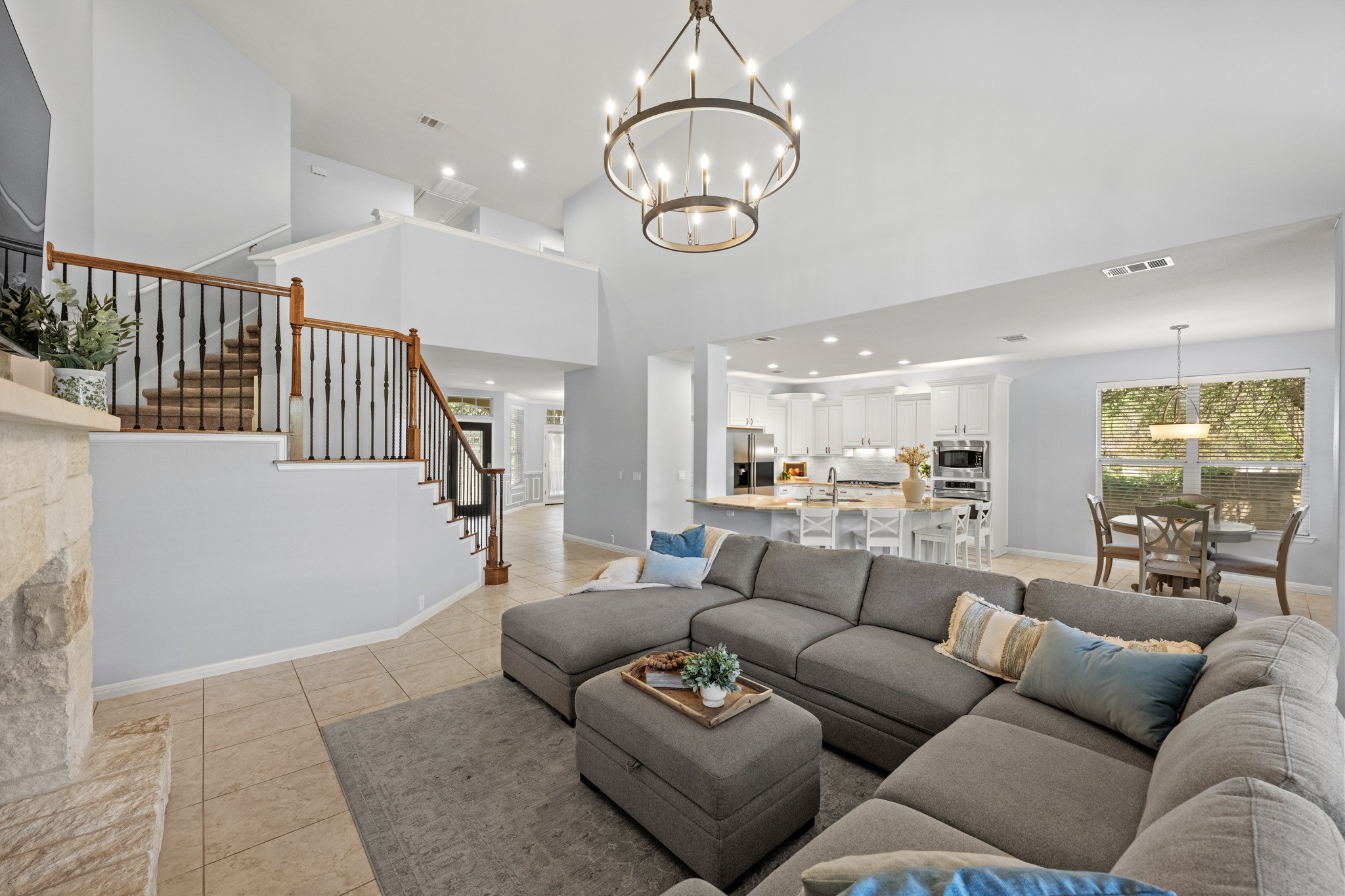 1023 Grassy Field Road Austin, TX 78737 - Photo 9 of 40 Expansive open-concept living area featuring high vaulted ceilings and tile flooring