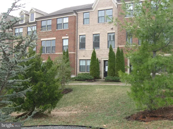 a view of a brick building next to a yard